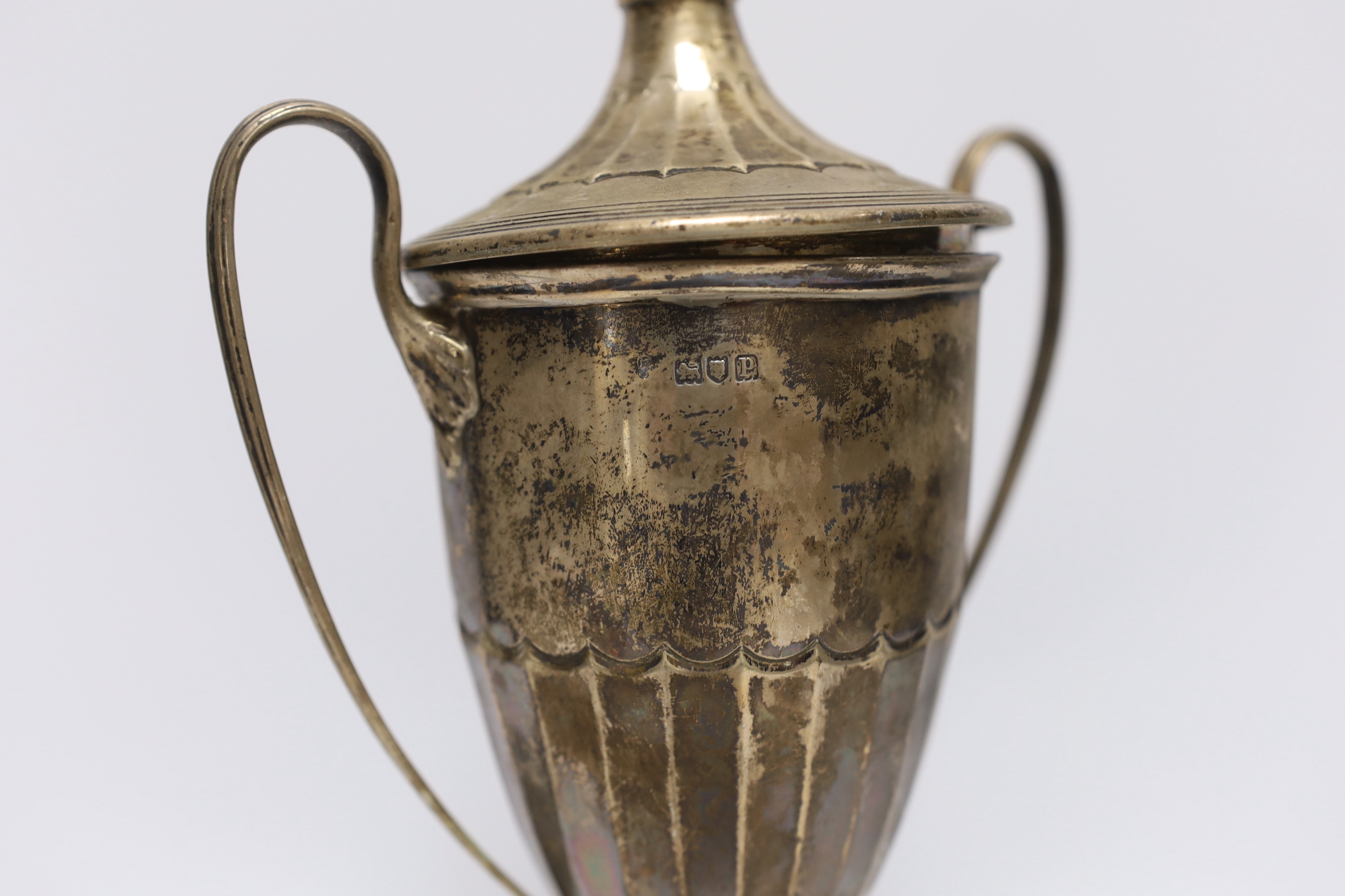 A George V silver two handled trophy cup and cover, London, 1910, on an ebonised base, cup height only, 24.5cm.